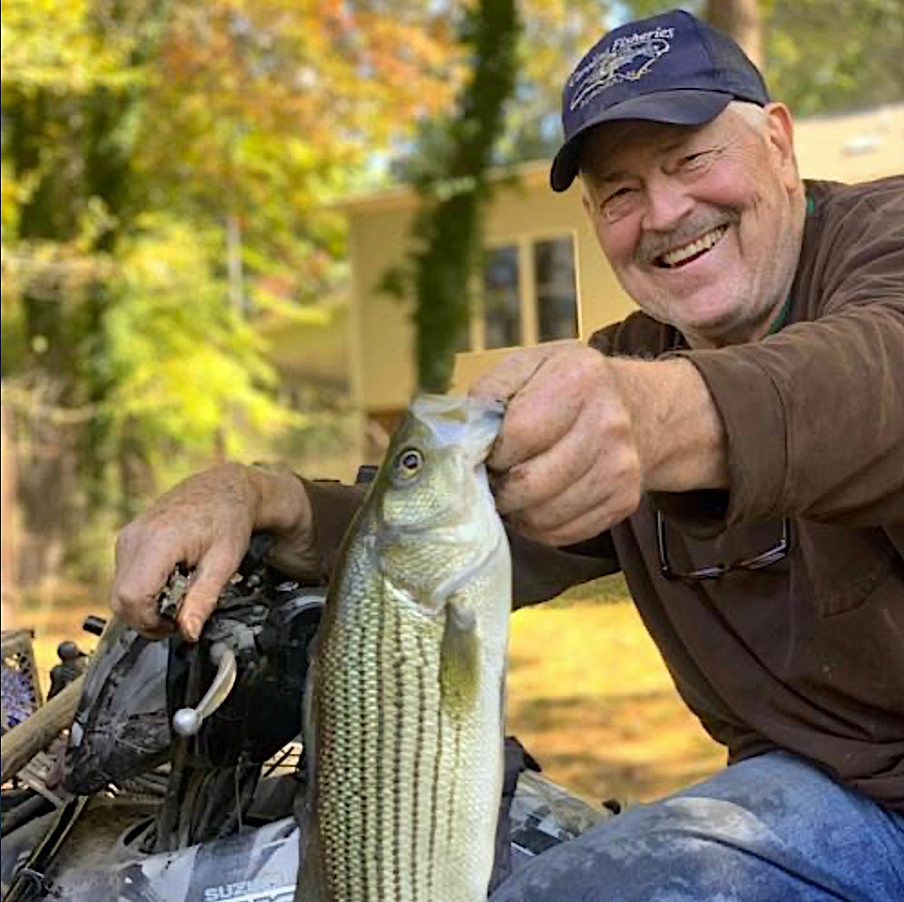 image: Ron Hodson with one of his hybrid striped bass.